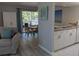 Bright living area featuring modern design, balcony access, and kitchen with snack bar at 2373 N Beach Rd # 1C, Englewood, FL 34223