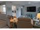 Inviting living room featuring open access to kitchen, cozy seating, and a large flat-screen TV at 2373 N Beach Rd # 1C, Englewood, FL 34223