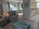 Comfortable living room featuring bright natural light, dining area, and open floor plan at 2373 N Beach Rd # 1C, Englewood, FL 34223