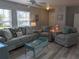 Comfortable living room featuring bright natural light, calming color palette, and coastal decor at 2373 N Beach Rd # 1C, Englewood, FL 34223