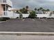 Exterior image of the property's on-site parking lot with parking spaces and manicured landscaping at 2373 N Beach Rd # 1C, Englewood, FL 34223