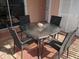 Inviting patio area with a glass-top table and seating for four at 2373 N Beach Rd # 1C, Englewood, FL 34223
