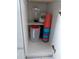A look inside of a lower storage cabinet with a blender, pitcher, and a stack of plastic cups at 2373 N Beach Rd # 1C, Englewood, FL 34223