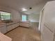 Bright kitchen with white cabinets and a breakfast bar, connecting to the living area at 2473 Woodyglen St, Port Charlotte, FL 33948