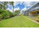 Spacious backyard with pool, shed, and lush tropical landscaping at 2588 Westberry Ter, North Port, FL 34286
