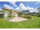 Expansive backyard featuring brick patio and screened-in lanai at 2588 Westberry Ter, North Port, FL 34286