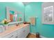 Bathroom features a white vanity, tile floors, and a decorative mirror at 2588 Westberry Ter, North Port, FL 34286