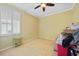 Bedroom with neutral carpet, white trim, shuttered window, and a ceiling fan at 2588 Westberry Ter, North Port, FL 34286