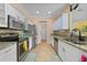 Modern kitchen boasts stainless steel appliances, granite countertops, and white cabinetry at 2588 Westberry Ter, North Port, FL 34286