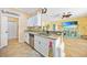 Well-lit kitchen features stainless steel appliances, tile floors and granite countertops at 2588 Westberry Ter, North Port, FL 34286