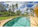 Inviting screened-in pool with clear water, tiled edge, and lush greenery views at 2588 Westberry Ter, North Port, FL 34286