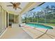 Screened lanai with in-ground pool and view of lush backyard at 2588 Westberry Ter, North Port, FL 34286