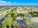 An aerial view of a home highlighting the large lot, screened-in pool, and the surrounding neighborhood at 262 Rotonda N Blvd, Rotonda West, FL 33947