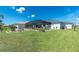 Well-maintained backyard with screened-in pool and patio, perfect for outdoor living and entertaining at 262 Rotonda N Blvd, Rotonda West, FL 33947