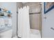 Well-lit bathroom featuring a bathtub with shower, tiled walls and coastal accents at 262 Rotonda N Blvd, Rotonda West, FL 33947