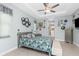 Bright bedroom featuring a ceiling fan, bed with floral comforter and built in dresser at 262 Rotonda N Blvd, Rotonda West, FL 33947
