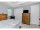 Comfortable bedroom featuring coastal decor, tiled floor and dresser at 262 Rotonda N Blvd, Rotonda West, FL 33947
