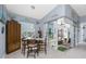 Cozy dining area with table, chairs, cabinet, and sliding glass doors to the outdoor space at 262 Rotonda N Blvd, Rotonda West, FL 33947