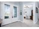 Bright foyer with tile flooring, glass double doors, and an open view into a living area with tray ceilings at 262 Rotonda N Blvd, Rotonda West, FL 33947