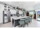 Bright kitchen with white cabinets, large island, stainless appliances and access to the pool area at 262 Rotonda N Blvd, Rotonda West, FL 33947