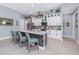 Modern kitchen with a center island, bar stool seating, white cabinets, stainless steel appliances, and tile flooring at 262 Rotonda N Blvd, Rotonda West, FL 33947