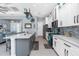 Open concept kitchen with white cabinetry, stainless steel appliances and island with bar seating at 262 Rotonda N Blvd, Rotonda West, FL 33947
