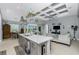 Open-concept kitchen featuring a center island with seating, modern appliances, and a seamless flow into the living area at 262 Rotonda N Blvd, Rotonda West, FL 33947