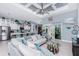Spacious living room featuring tile floors, modern decor, a large ceiling fan, and an open layout to the kitchen at 262 Rotonda N Blvd, Rotonda West, FL 33947