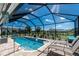 Screened-in pool with a beautiful backyard view, lounge chairs, and clear blue water, perfect for relaxation at 262 Rotonda N Blvd, Rotonda West, FL 33947