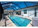 The screened-in pool features a well-maintained patio with chairs for relaxing by the clear blue water at 262 Rotonda N Blvd, Rotonda West, FL 33947