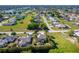 Aerial view of a residential community with a lake and palm trees at 26294 Bridgewater Rd, Punta Gorda, FL 33983