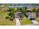 Aerial view of a home with a well-manicured lawn, mature palm trees, and lush landscaping at 26294 Bridgewater Rd, Punta Gorda, FL 33983