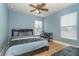 Comfortable bedroom with light blue walls, a bed, a ceiling fan, and a desk at 26294 Bridgewater Rd, Punta Gorda, FL 33983