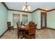 Elegant dining room featuring wood accents, a classic chandelier, and bright natural light at 26294 Bridgewater Rd, Punta Gorda, FL 33983