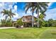 Well-manicured lawn and tropical landscaping surround this inviting two-story home at 26294 Bridgewater Rd, Punta Gorda, FL 33983