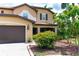 Charming home exterior with brown trim and accents, framed by colorful flowers and lush greenery at 26294 Bridgewater Rd, Punta Gorda, FL 33983