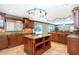 Open-concept kitchen with custom cabinets, granite countertops, stainless steel appliances, and a center island with cooktop at 26294 Bridgewater Rd, Punta Gorda, FL 33983