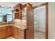 Kitchen with custom cabinetry, granite countertops, stainless appliances and an adjacent pantry at 26294 Bridgewater Rd, Punta Gorda, FL 33983