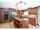 Gourmet kitchen features custom cabinets, granite countertops, stainless steel appliances, and a center island with cooktop at 26294 Bridgewater Rd, Punta Gorda, FL 33983
