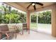 Enclosed lanai featuring outdoor seating, a ceiling fan, and views of lush tropical landscaping at 26294 Bridgewater Rd, Punta Gorda, FL 33983