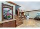 Open living room featuring tile floors, stairs, bar seating and kitchen access at 26294 Bridgewater Rd, Punta Gorda, FL 33983