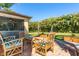 Charming patio space with brickwork, wooden furnishings, string lights, and a covered lanai at 26294 Bridgewater Rd, Punta Gorda, FL 33983