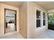Covered porch with tile floors and neutral paint featuring an open door and screened lanai access at 26294 Bridgewater Rd, Punta Gorda, FL 33983