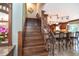 Elegant wood staircase leading to a stylish kitchen with granite countertops and bar seating at 26294 Bridgewater Rd, Punta Gorda, FL 33983