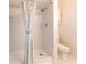 Bright bathroom featuring a white tiled shower with a patterned curtain and a modern toilet at 3085 Crowder St, Punta Gorda, FL 33980