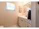 Bathroom featuring a white vanity, window, and decorative wall art at 3085 Crowder St, Punta Gorda, FL 33980