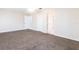 Large bedroom with carpet flooring, neutral walls, and access to the ensuite bathroom at 3085 Crowder St, Punta Gorda, FL 33980