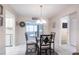 Cozy dining area with a modern glass table, seating for four, and a view into the living room at 3085 Crowder St, Punta Gorda, FL 33980