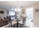 Inviting dining area with a glass-top table, seating for four, and seamless flow to the living room and kitchen at 3085 Crowder St, Punta Gorda, FL 33980