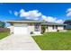 Charming single-story home with a well-maintained lawn, attached garage, and inviting front entrance at 3085 Crowder St, Punta Gorda, FL 33980